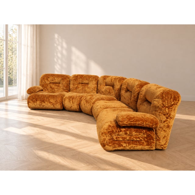 The set retains its original period upholstery in soft ochre/brown velvet, with the sinuous, enveloping lines typical of...