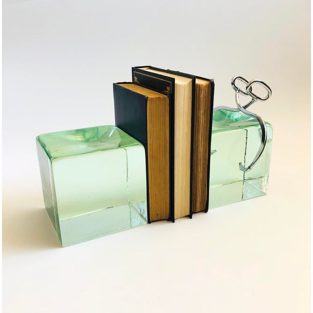 A pair of rare mid century ice block bookends by Curtis Jere. Heavy in weight with one side having chrome tongs. No...
