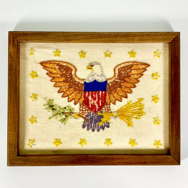 This 1930s Yarn Needlepoint Sampler features a patriot Golden Eagle surrounded by gold stars. The Eagle has an olive...