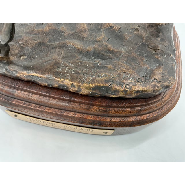 A powerful and masterfully executed bronze sculpture by acclaimed Western artist Dee Adams Prater, Mustang Challenge...