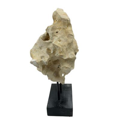 Natural coral stone from Indonesia with a sandy hue, displayed on a handcrafted teak stand. Its organic texture and warm...