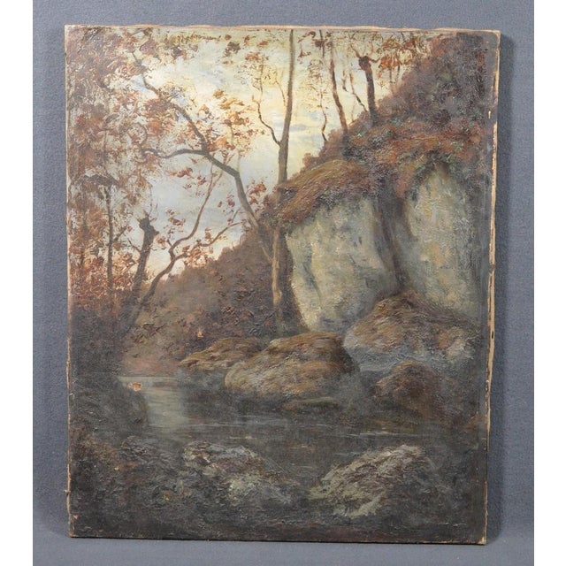 Antique French Woodland Landscape Oil Painting With Rocks and Stream A charming antique oil painting on canvas depicting a...