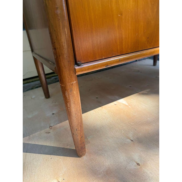 Bring classic Mid-Century Modern sophistication into your space with this exceptional walnut cabinet from Henredon's...