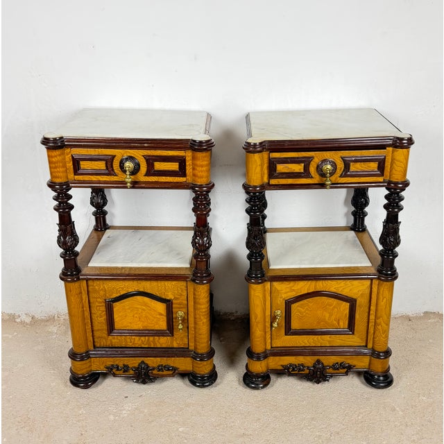 Elegant pair of French Empire style nightstands, distinguished by their striking combination of richly figured wood...