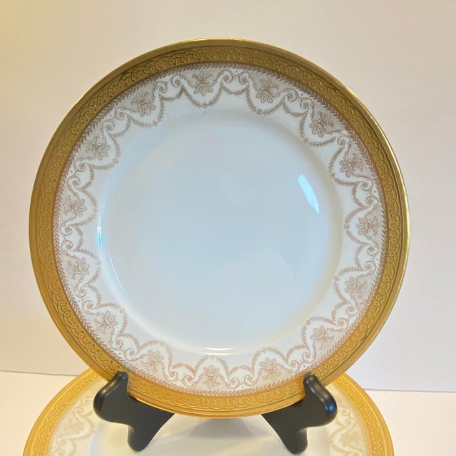 An elegant set of antique French Limoges salad or luncheon plates by Wm. Guérin & Co., featuring a richly gilded rim with...