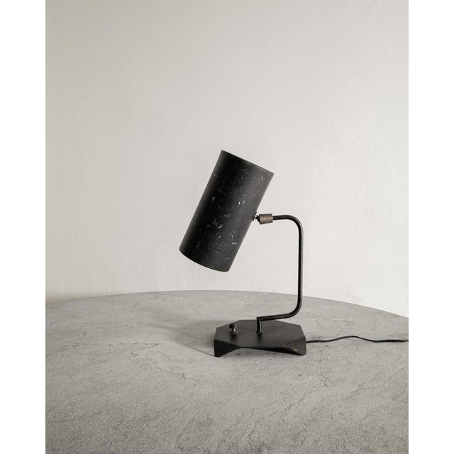 A very rare mid century " tuyaux" desk table lamp in black lacquered metal and patinated brass with an adjustable shade by...