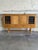 This oak sideboard in style of Henning Kjærnulf stands on turned legs with double stretchers. Two stained glass outer...
