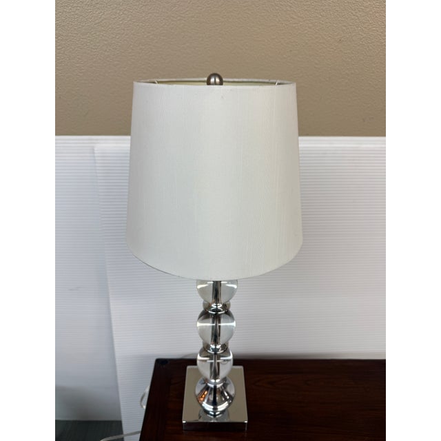 Design Plus Gallery presents an Acrylic Orb Table Lamp. Stacked on polished chrome column and base, the three orbs climb...