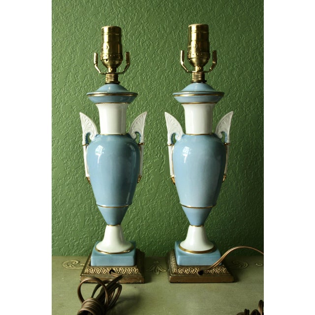 An elegant matching pair of vintage DE LITE porcelain table lamps in a soft powder-blue and white colour palette,...
