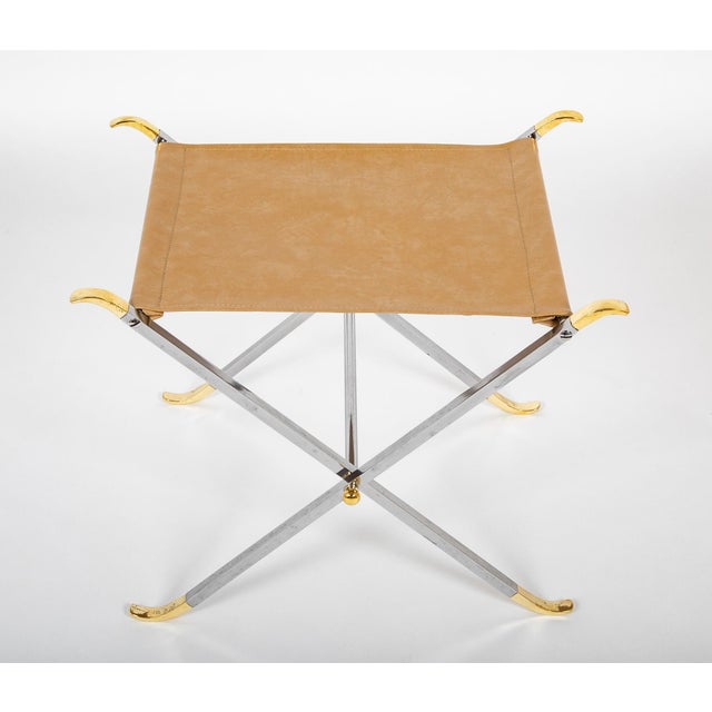 Quite elegant pair of polished steel and brass X-from stools with taupe leather seats. A very successful interpretation of...