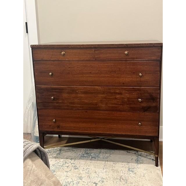 Iconic Paul McCobb five-drawer chest for Calvin Furniture, Model 1003, dating to the 1950s. Rich mahogany is paired with...