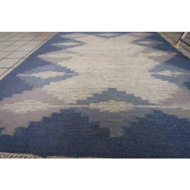 Handmade vintage Persian Ardabil kilim in white and blue colors and geometric design. The rug is from the end of 20th...