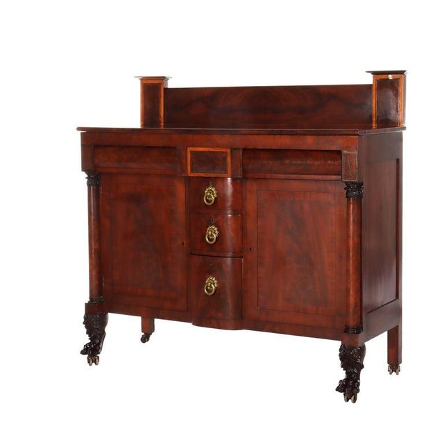 An exquisite American Empire Classical sideboard, crafted from flame mahogany around 1840, exemplifies the refined...