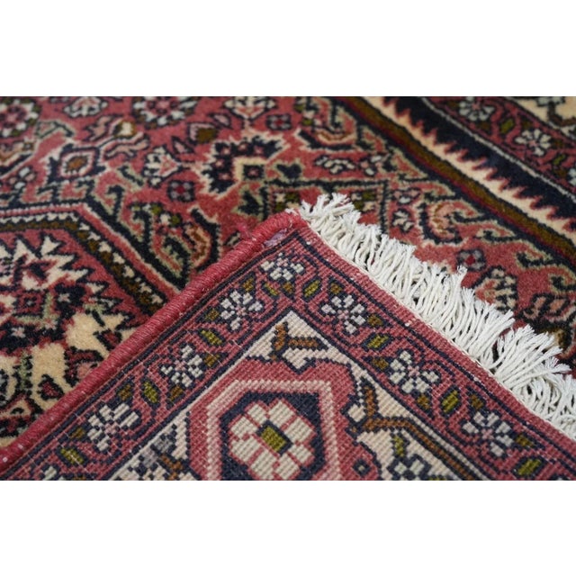 All Herati field with cream central hexagon, rose sub-field and navy field deploying as stepped triangular corners. A...