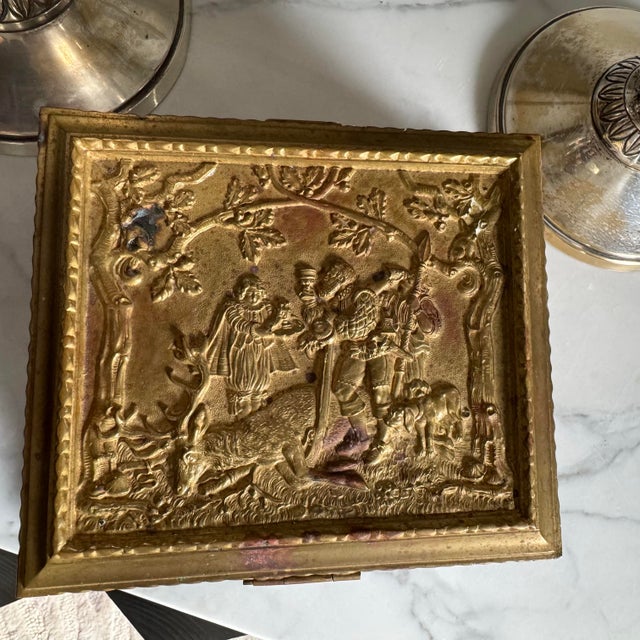 This is a beautifully designed box with various hunting scenes exquisitely sculptured on all sides. Inside there are 2...