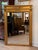 Early 19th C. French carved giltwood mirror with a stepped cornice. The upper frieze carries a central wreath flanked by...