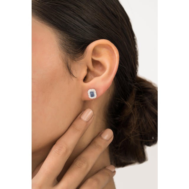 These elegant stud earrings featuring 0.88 carat emerald-cut blue sapphires set in 14K white gold, each measuring...