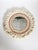 Decorative round wall mirror made in France in the 21st century. The circular mirror is surrounded by an elaborate textile...