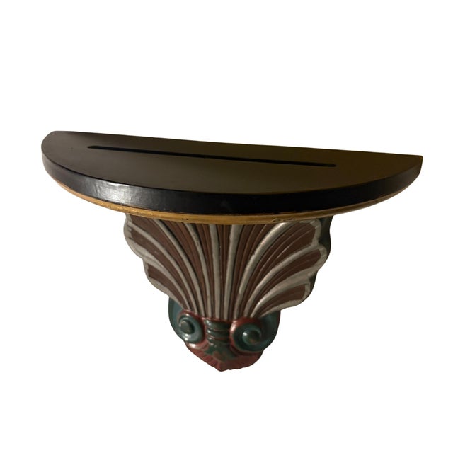 Decorative shelf made of a brass shell bracket with a wooden shelf above it. The shelf has a 6 inch recessed groove so...