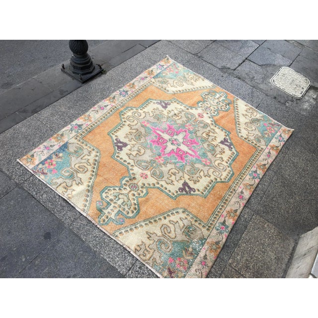 This is a vintage Turkish Oushak rug from the 1960s. The piece was hand-knotted.