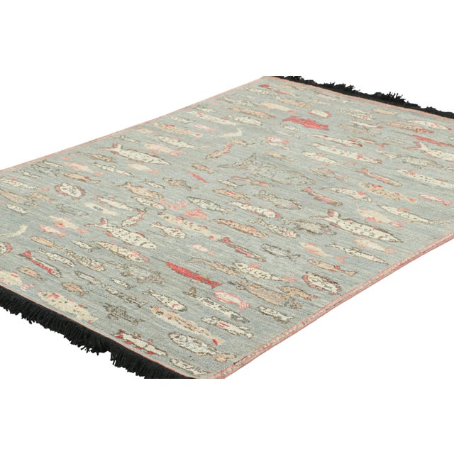 Made with hand-knotted Ghazni wool, this 4x6 rug from Rug & Kilim’s Burano collection features schools of stylized fish...