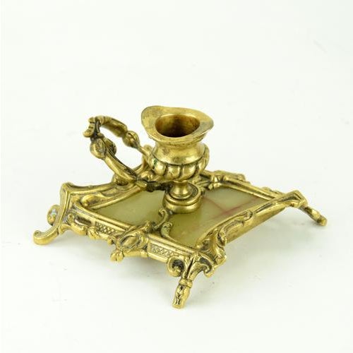 An exceptional candlestick made of brass and onyx. The impressive craftsmanship of the brass highlights the superior...
