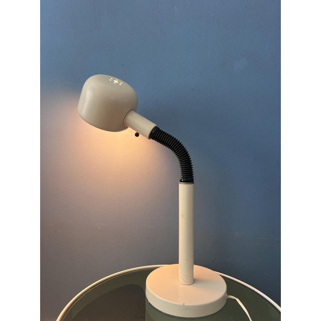 Mid-century space age cobra table lamp featuring a sculptural gooseneck design. The adjustable gooseneck arm allows the...