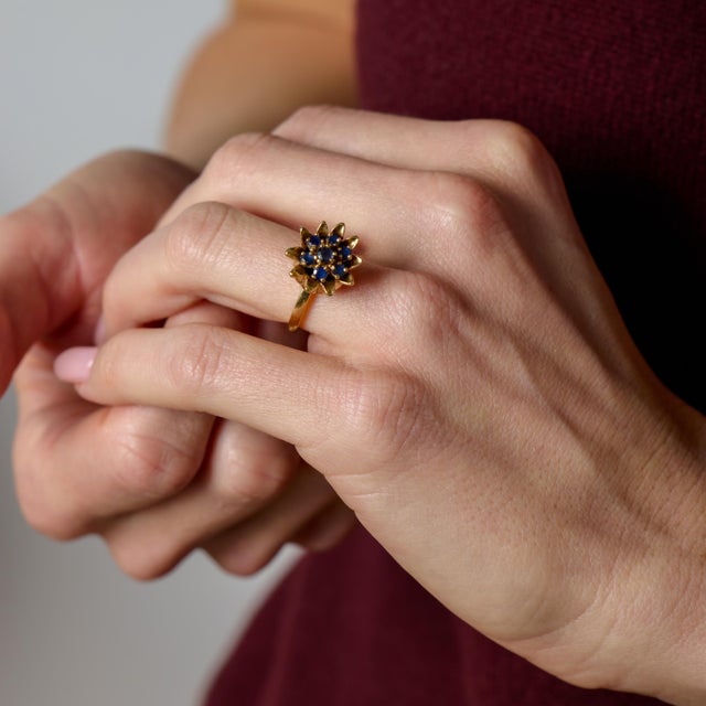 This vintage sapphire ring is a refined expression of classic color and enduring design. Seven round cut blue sapphires...
