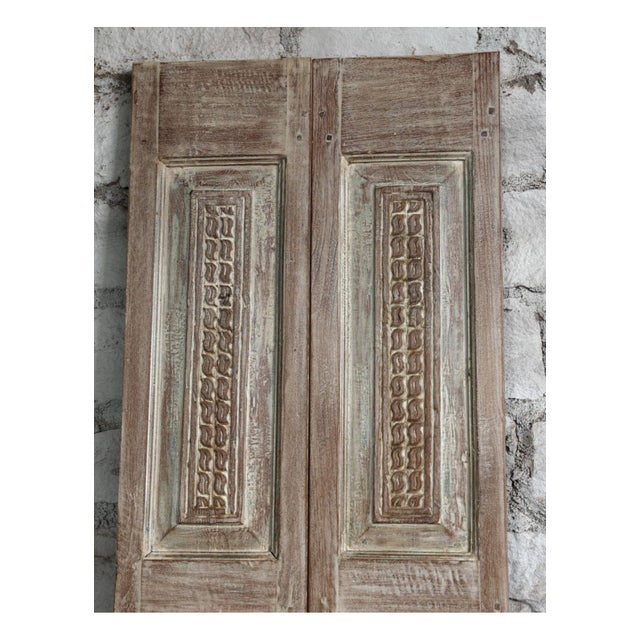 A rare pair of antique French double doors featuring exquisite hand-carved detailing and a rich, timeworn patina. Crafted...