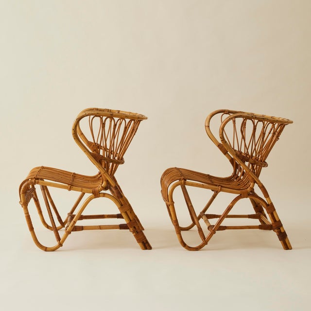 Danish designed iconic rattan "Fox" chairs, vintage originals by Viggo Boesen. Boesen designed a number of pieces of...