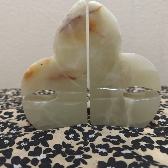 These striking bookends are crafted from natural onyx, often referred to as "Mexican onyx" or banded calcite. Dating...