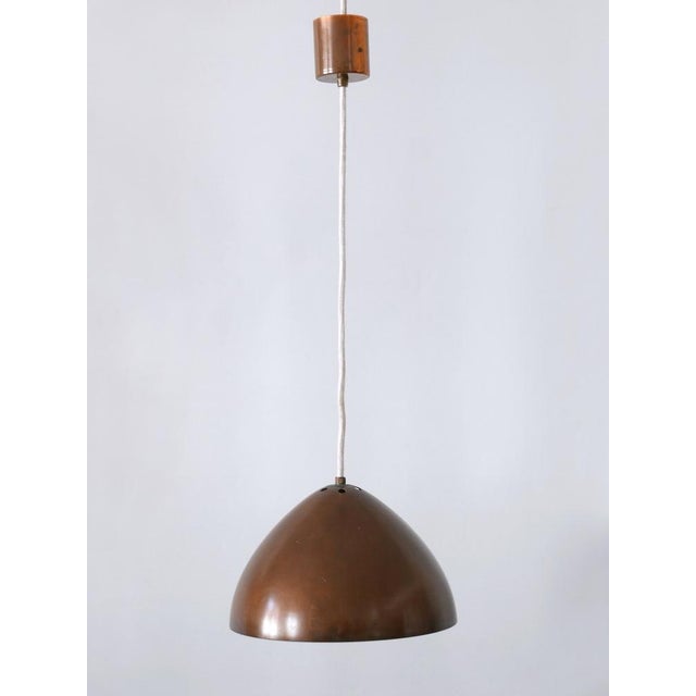 Rare, lovely and elegant mid-century modern copper pendant lamp or hanging light. Designed & manufactured probably in...