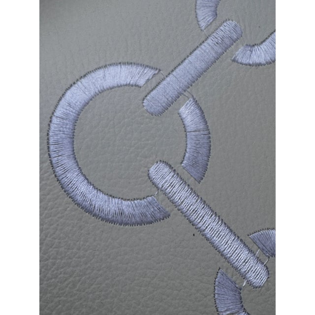 Contemporary and in like new condition. Silver chrome bases with heft, tops are embroidered around the edge and white faux...