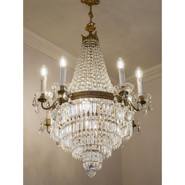 Vintage italian chandelier from the 1950s in the empire style, crafted from brass, crystal, and cut glass. the basket-...