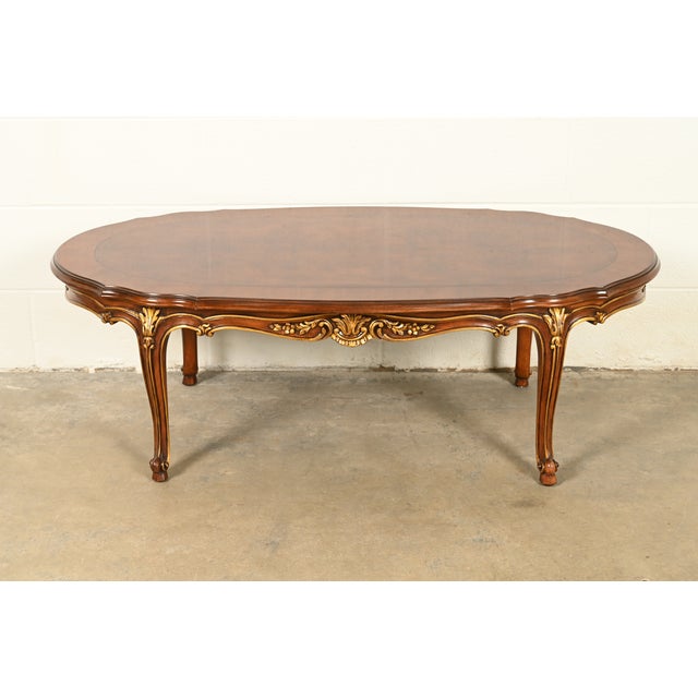 A gorgeous French Rococo Louis XV and French Provincial style banded walnut parcel giltwood coffee table By Karges USA,...