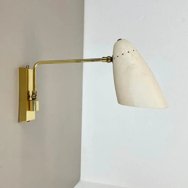 Article: brass theatre wall light Origin: Italy Age: 1950s This modernist light was produced in Italy in the 1950s in...