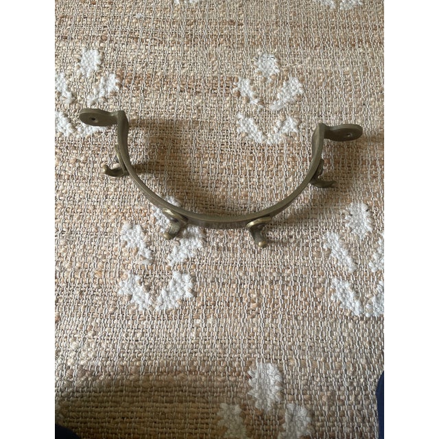 This early 20th century bronze and copper half circle pot rack is a unique and functional collectible piece. The...