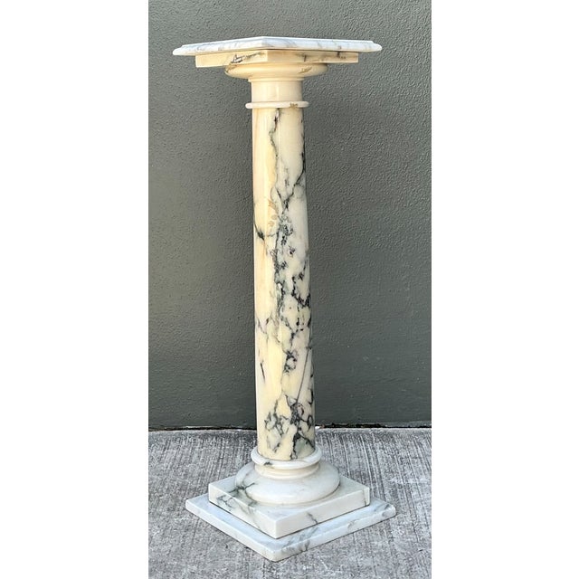 This vintage marble column pedestal channels the enduring elegance of Neoclassical design. Carved from richly veined...