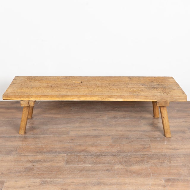 Rustic wood coffee table with squared splay legs and loaded with vintage character. The thick top is made from planks...