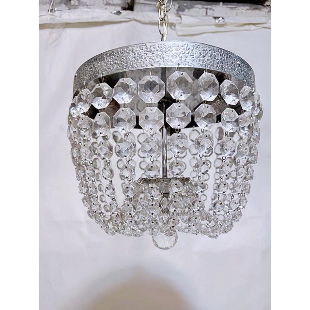 Italian Basket chandelier with bronze rim and 30% led A-chain chain and U-drop. It has 3 candelabra base sockets the each...