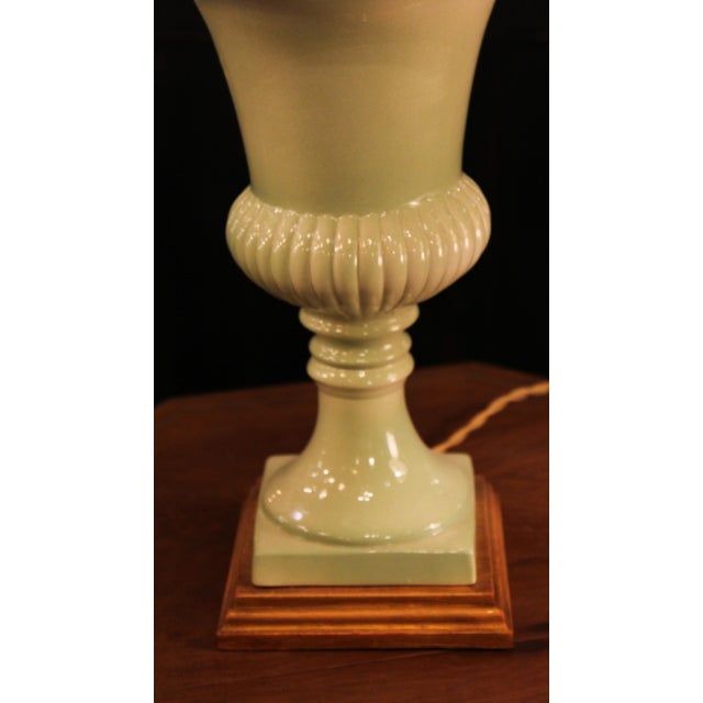 This ceramic lamp, glazed in a soft, light green hue, is inspired by the artisanal tradition of Manises, renowned for its...