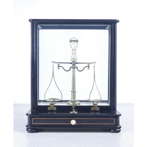 Precision pharmacy scale, black lacquered wooden case, with a pan-lifting mechanism, drawer, and weights. Italy, early...