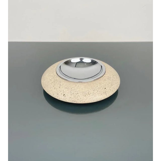 Round ashtray or Vide-Poche in travertine marble and steel. Made in Italy in the 1970s. The original label is still...