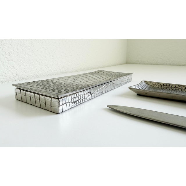 A rare set of desk accessories crafted of pewter and embossed with a crocodile pattern. Made in France circa 1970s-1980s....