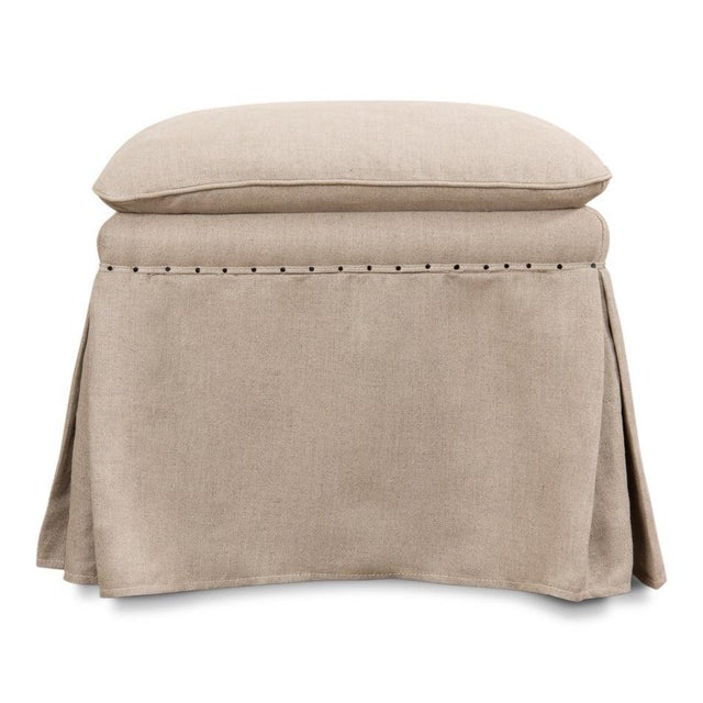 Tailored linen skirts fall to the floor on all four sides, with crisp corner pleats and a row of tacks where the cloth...