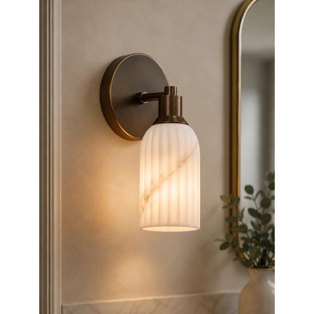 Add a warm, refined accent to the wall with this handcrafted brass wall sconce, featuring a clean circular backplate,...