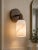 Add a warm, refined accent to the wall with this handcrafted brass wall sconce, featuring a clean circular backplate,...