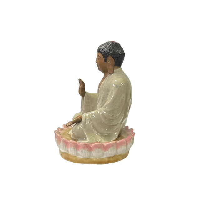The Chinese Ceramic Beige Color Sitting Buddha Amitabha on Lotus Statue is a meticulously crafted and aesthetically...