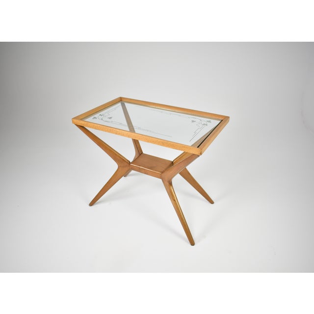 An Italian coffee table in wood and glass, dating from the 1940s–50s and designed in the style of Cesare Lacca. The table...