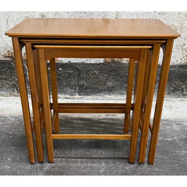 Quintessential set of three space-saving nesting tables from Sweden, embodying the functional elegance of the Mid-Century...